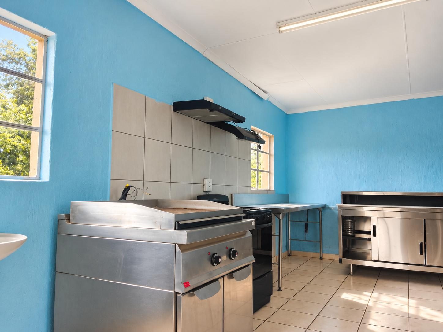 Shared kitchen with a gas griddle, stove and stainless-steel worktops
